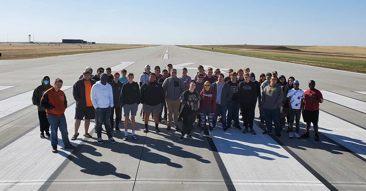 Bismarck aviation academy students pose for a photo on Fargo airport runway